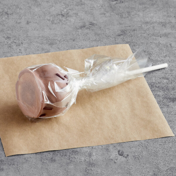 A chocolate cake pop in a plastic wrapper.