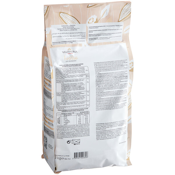 A bag of Valrhona Ivoire white chocolate feves on a white background.