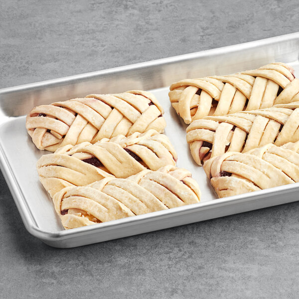 A gray tray holding four braided blueberry pastries.