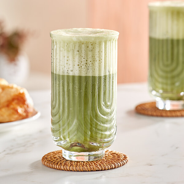 An Acopa Zelda highball glass with green liquid in it.