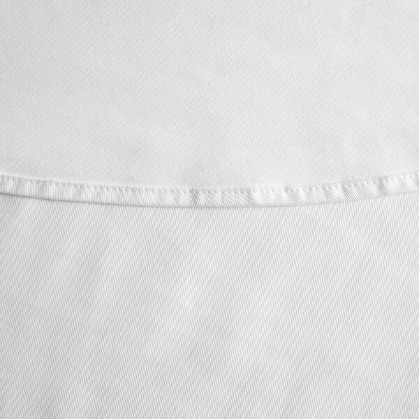 A close up of a white hemmed Intedge poly cotton tablecloth.