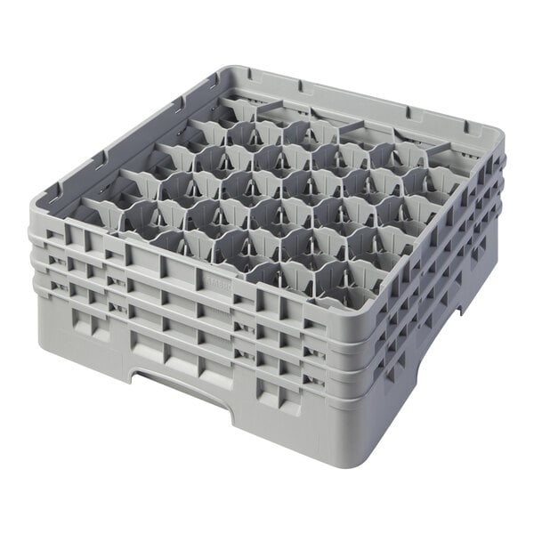 A grey plastic Cambro glass rack with 30 compartments and extenders.
