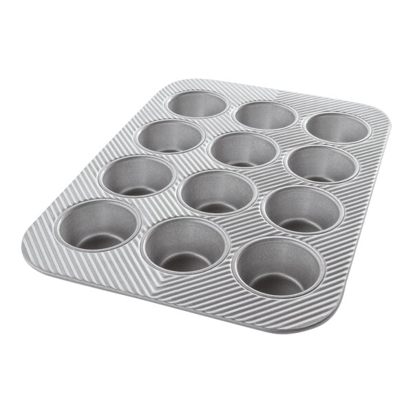 A silver Chicago Metallic muffin pan with 12 cupcake holes.