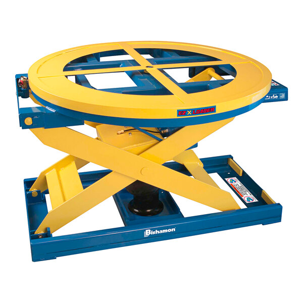 A yellow and blue Bishamon self-leveling pallet positioner with a blue wheel.