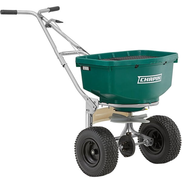 A green Chapin landscape spreader with wheels.