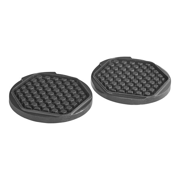A pair of black rubber pads with hexagons on them.