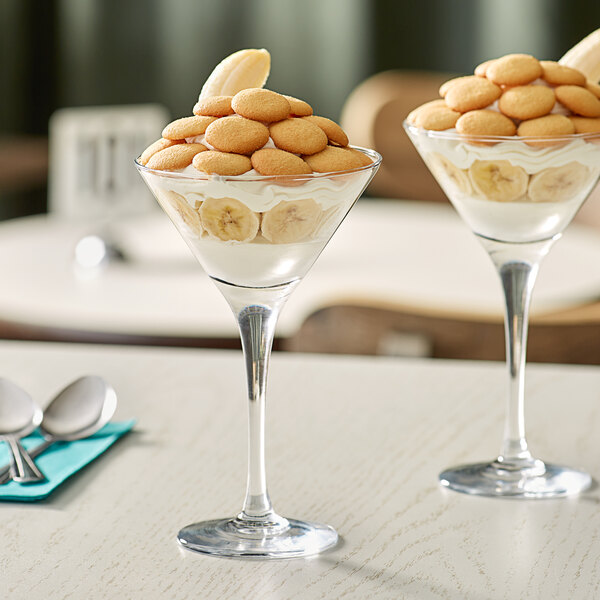 An Acopa Select martini glass filled with ice cream and bananas on a table.