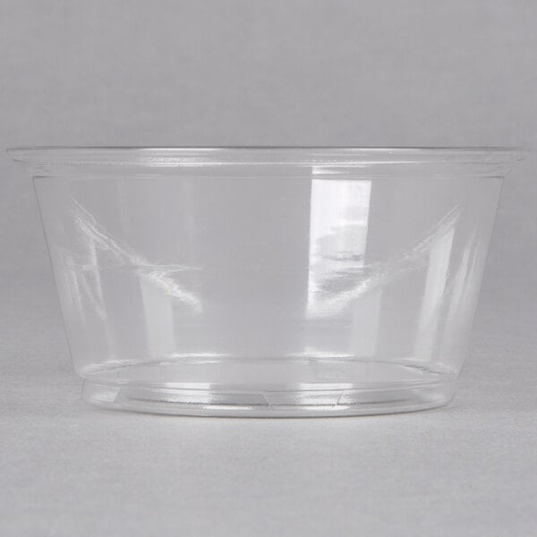 A clear plastic container with a lid on a white surface.