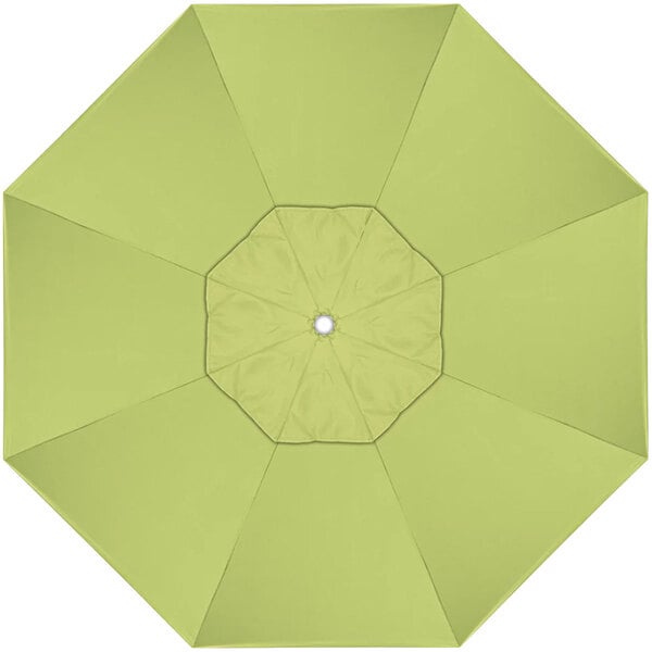 A green California Umbrella with a white center open on a stand.