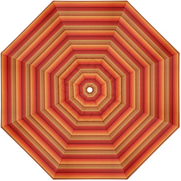 A white umbrella with orange and brown striped canopy.