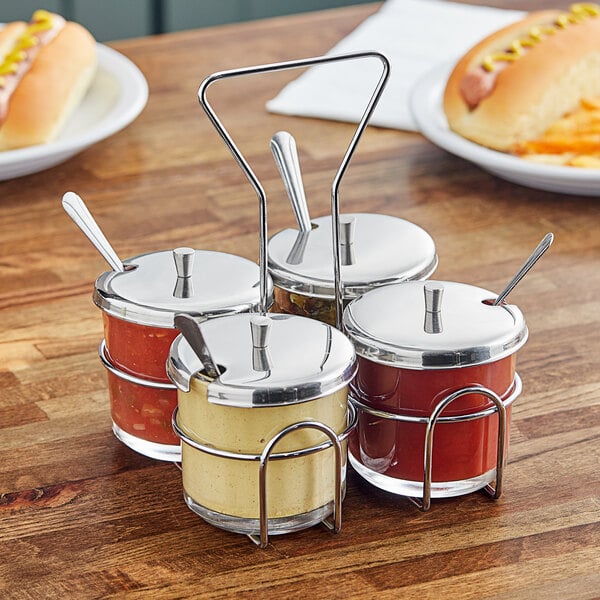 A Choice metal condiment caddy on a table with condiments in it.