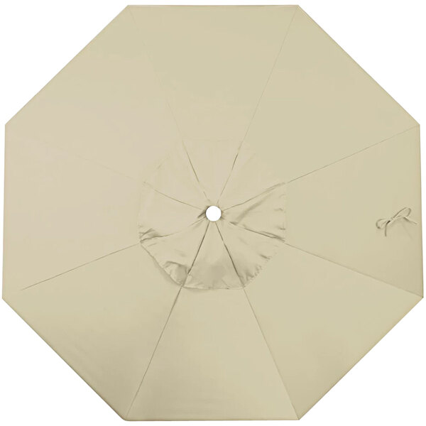 An open beige California Umbrella replacement canopy with a circle in the middle.