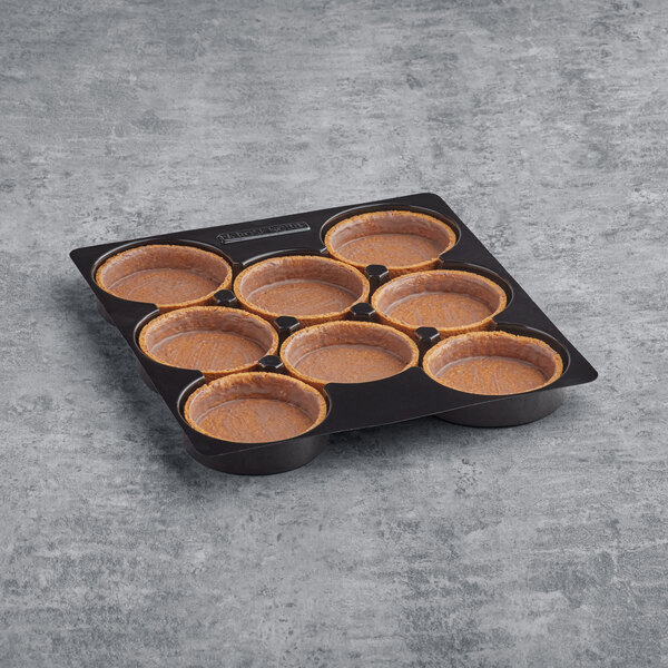 A tray of La Rose Noire extra large round graham cracker tart shells.