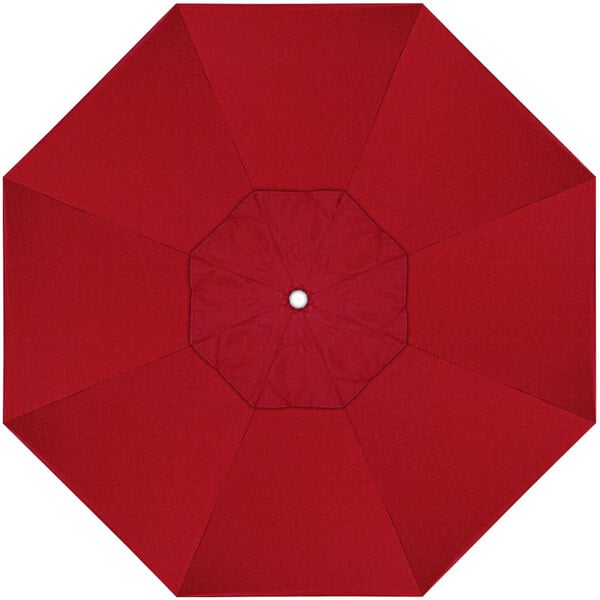 A red sunbrella canopy with a white center and a hole in the middle.