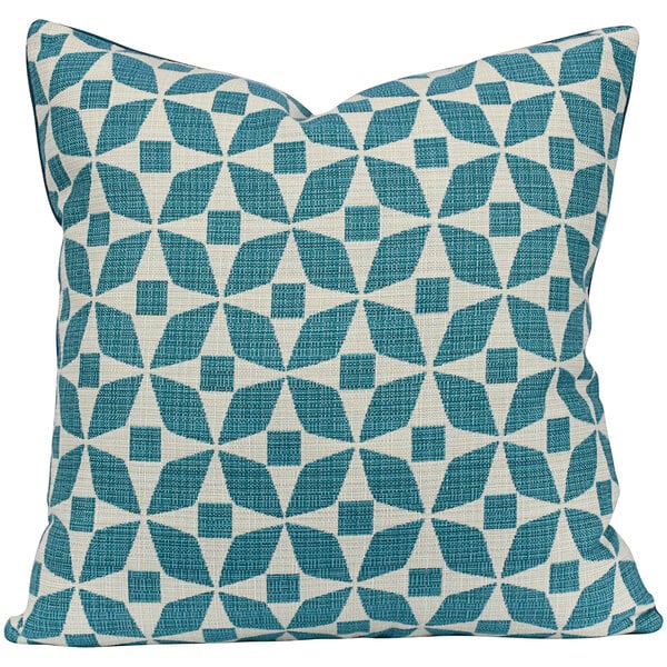 An Astella turquoise and petrol throw pillow with a blue and white geometric pattern.