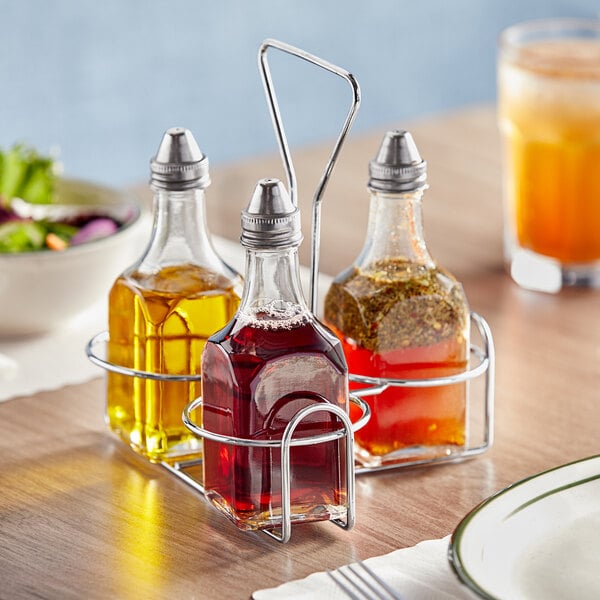 A group of bottles of liquid in a metal holder.