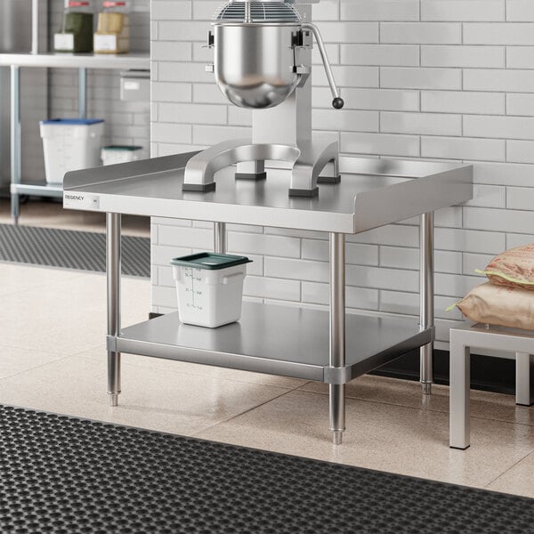 A stainless steel Regency equipment stand with a container on it.