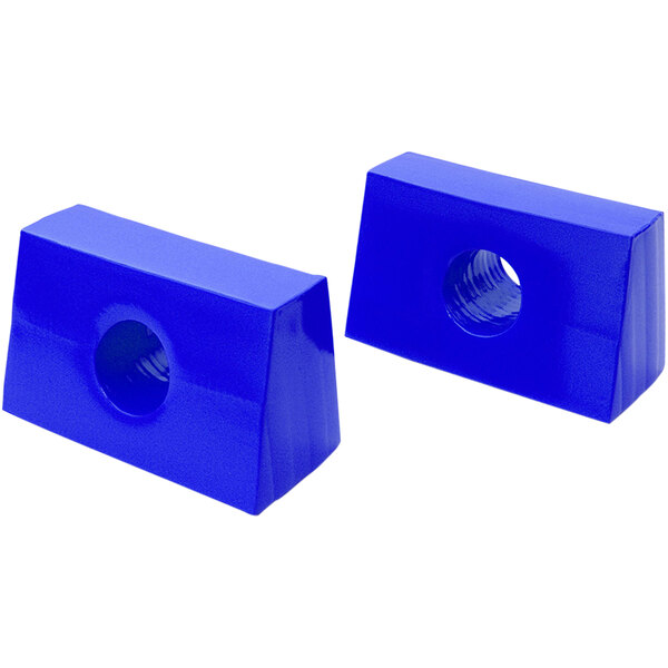 Two royal blue plastic blocks with holes in them.