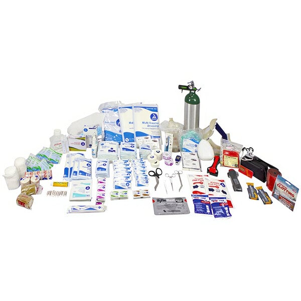 A white container filled with a variety of first aid supplies including a Kemp USA 570-piece Medical Supply Pack H.