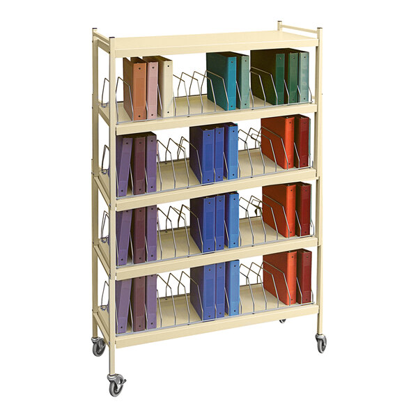 An Omnimed beige metal cart with several binders on it.