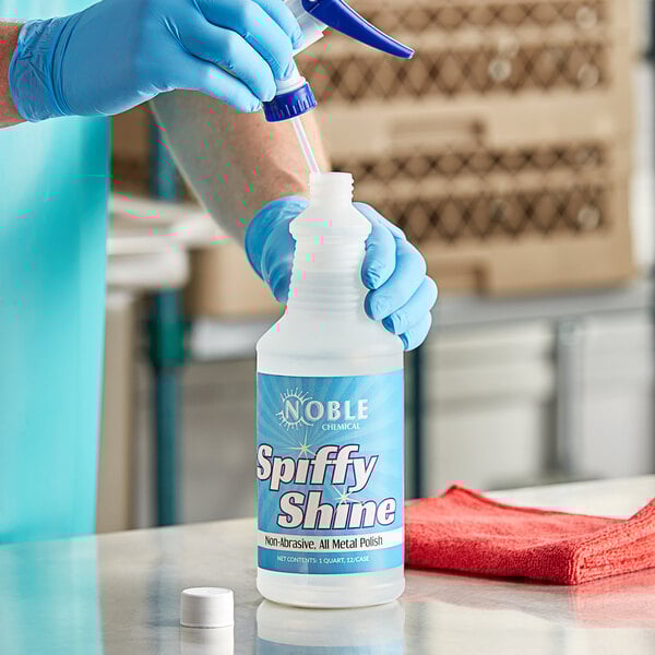 A person in blue gloves pouring Noble Chemical Spiffy Shine into a bottle.