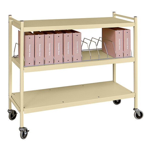 An Omnimed beige metal cart with file folders on it.