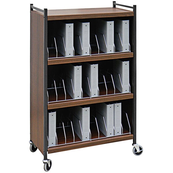 An Omnimed woodgrain medical cart with shelves holding binders.