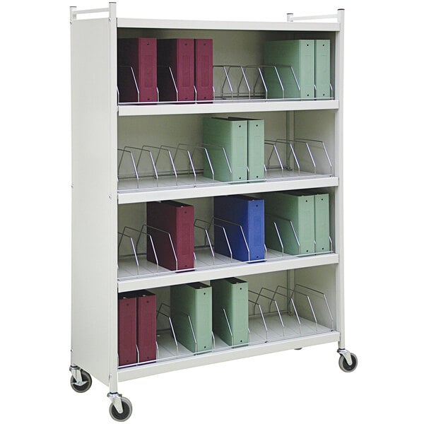 A white metal shelf with Omnimed binders on it.