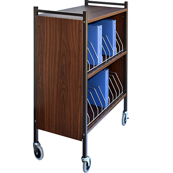 An Omnimed woodgrain medical cart with blue binders on it.