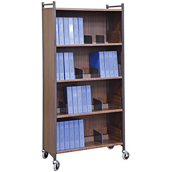 An Omnimed Versa woodgrain cabinet rack with shelves holding blue folders.