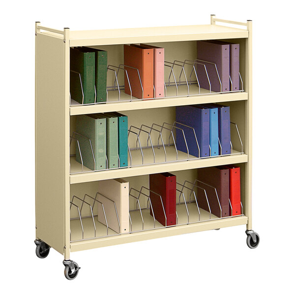 A beige Omnimed Omnicart with binders on it.