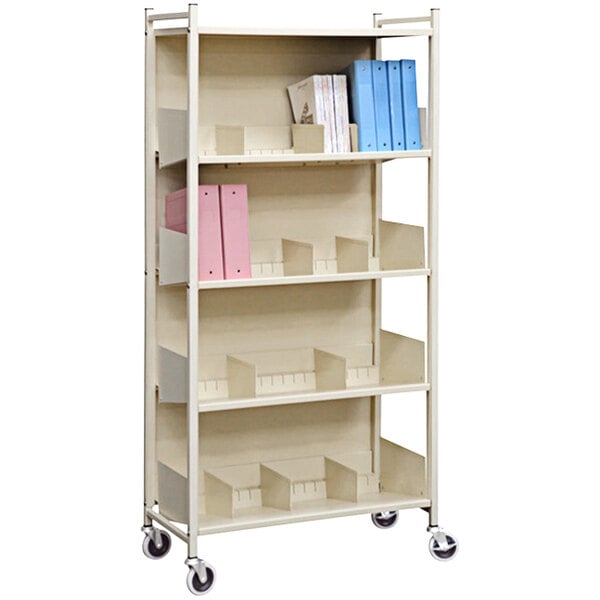 A beige metal Omnimed 4-shelf cabinet rack with binders on it.