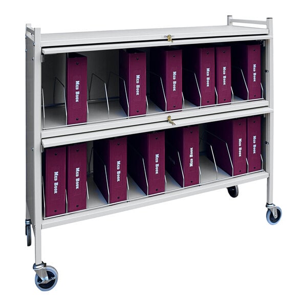 An Omnimed light gray medical cart with purple binders on it.