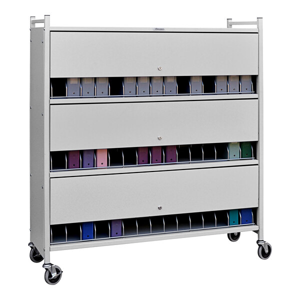 A light gray metal Omnicart with many closed white metal drawers.