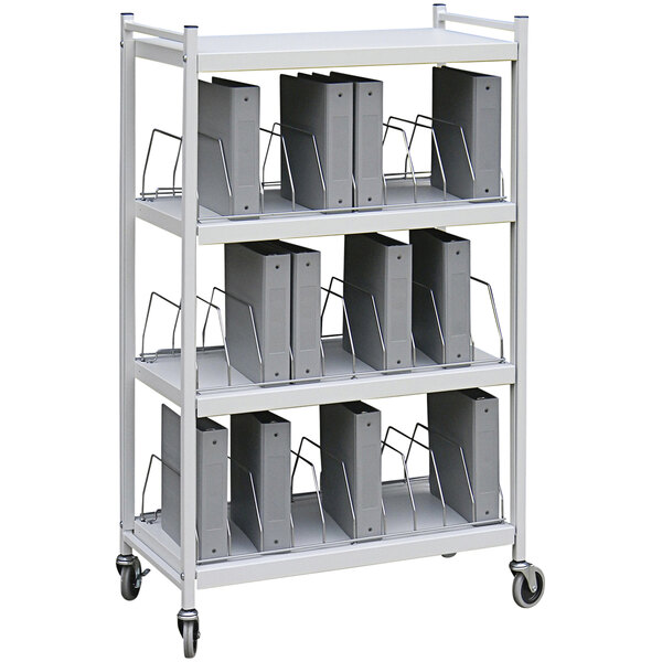 An Omnimed light gray metal cart with binders on a shelf.