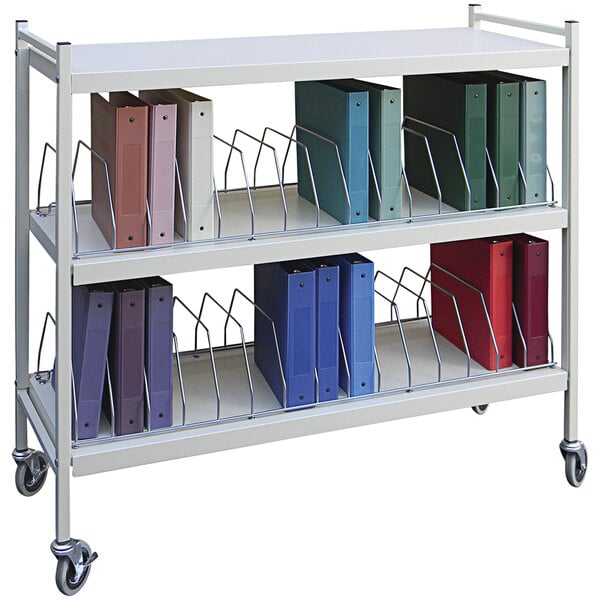 A white metal Omnimed horizontal cart with binders on it.