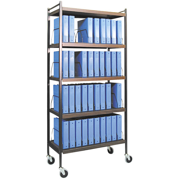 An Omnimed woodgrain medical cart with blue binders on shelves.