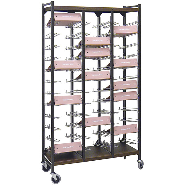 An Omnimed woodgrain metal cart with pink boxes on it.