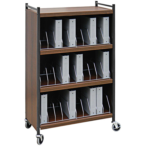 An Omnimed woodgrain cart with binders on it.