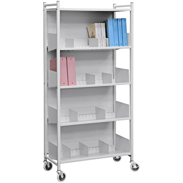 An Omnimed light gray metal open cabinet rack with shelves holding books and binders.