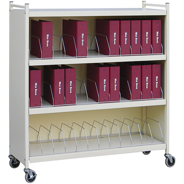 An Omnimed beige metal cart with binders on the shelves.