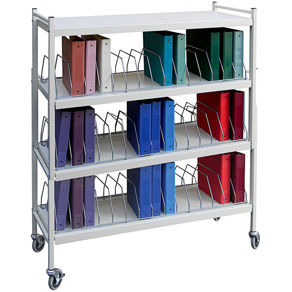 A light gray Omnimed medical cart with white metal shelves holding binders.