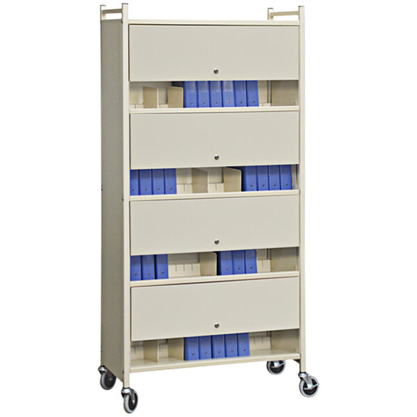 A beige Omnimed medical cart with blue folders on a shelf.