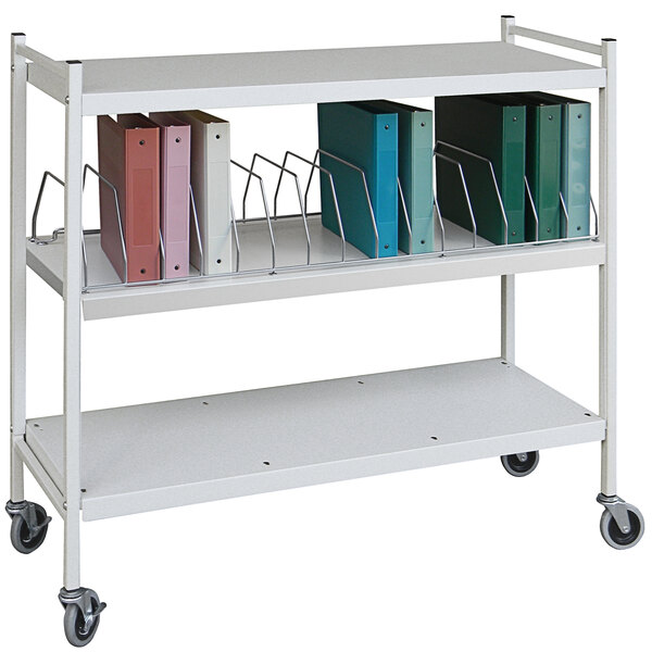 An Omnimed beige metal cart with binders on it.