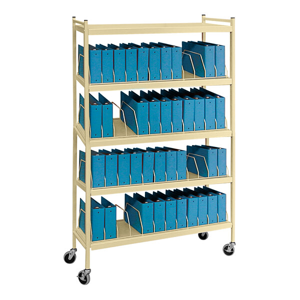 An Omnimed beige metal cart with blue file folders on it.