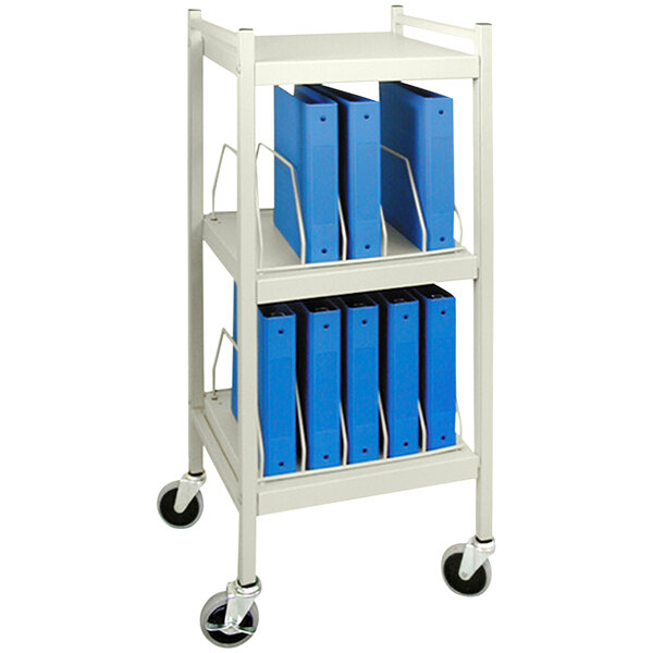 An Omnimed beige cart with blue binders on it.
