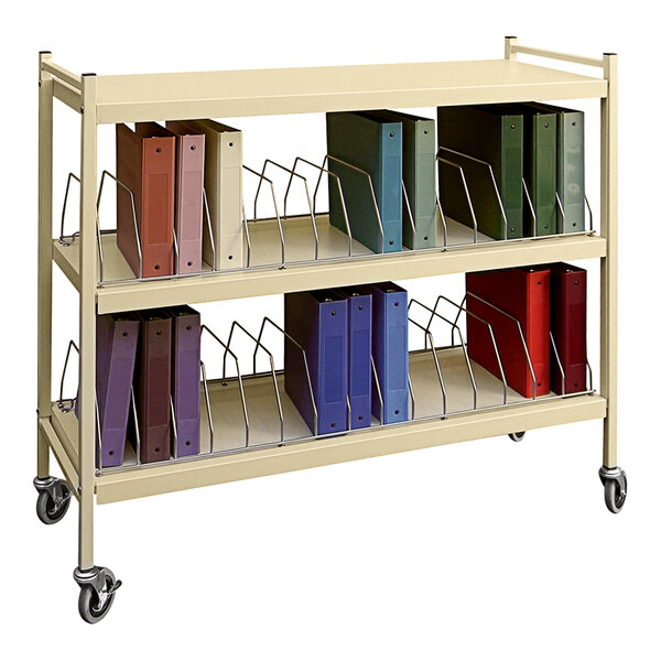 An Omnimed beige horizontal cart with binders on it.