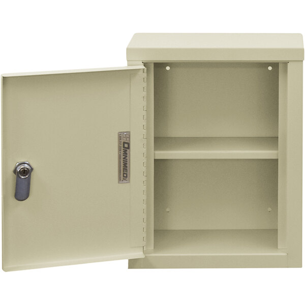 A beige metal Omnimed wall-mount cabinet with key lock.