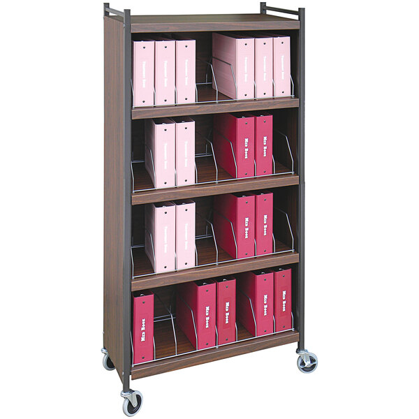 An Omnimed woodgrain closed cart with binders on the shelves.