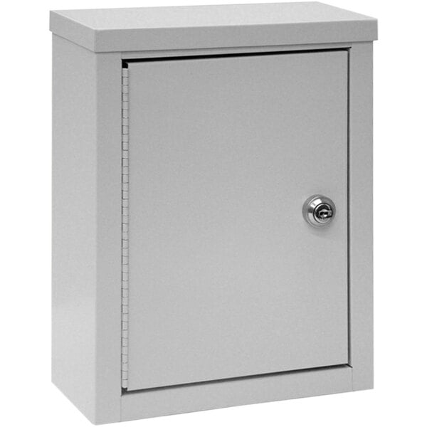 A light gray metal Omnimed wall-mount storage cabinet with a key lock.